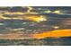 Dramatic sunset over the water with sun rays breaking through clouds at 200 Colony Point S Rd, St Petersburg, FL 33705