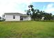 Spacious backyard with a large grassy area at 23335 Mac Dougall Ave, Port Charlotte, FL 33980