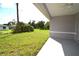 Spacious backyard with grassy lawn and covered patio at 23335 Mac Dougall Ave, Port Charlotte, FL 33980