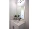 Vanity with white cabinets and quartz countertop, modern mirror at 23335 Mac Dougall Ave, Port Charlotte, FL 33980