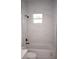 Bathroom with white marble-look tile and bathtub at 23335 Mac Dougall Ave, Port Charlotte, FL 33980