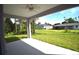 Covered patio with ceiling fan and view of backyard at 23335 Mac Dougall Ave, Port Charlotte, FL 33980