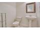 Small bathroom with pedestal sink, toilet, and glass shelf at 1344 Ribolla Dr, Palm Harbor, FL 34683