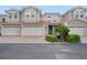 Three-story townhome with two-car garage and landscaped front at 1344 Ribolla Dr, Palm Harbor, FL 34683