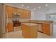 Kitchen with light wood cabinets, granite counters, and island at 1344 Ribolla Dr, Palm Harbor, FL 34683