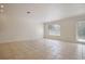 Bright living room with tile floors and access to balcony at 1344 Ribolla Dr, Palm Harbor, FL 34683