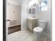 Updated bathroom features a vanity with double sinks, toilet and marble-look flooring at 1220 36Th W Ave, Bradenton, FL 34205