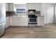 Updated kitchen with stainless steel appliances and tile backsplash at 1220 36Th W Ave, Bradenton, FL 34205