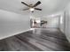 View of living room, kitchen, and wood-look floors at 1220 36Th W Ave, Bradenton, FL 34205