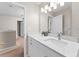 Bright bathroom boasts a vanity with marble countertop, and a large mirror at 10617 Bamboo Rod Cir, Riverview, FL 33569