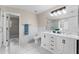 Elegant bathroom with double vanity, marble flooring, and a walk-in shower at 10617 Bamboo Rod Cir, Riverview, FL 33569