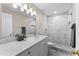 Bathroom with white vanity, marble tile, and a shower/tub combo at 10617 Bamboo Rod Cir, Riverview, FL 33569