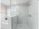 Large walk-in shower with marble tile and glass enclosure at 10617 Bamboo Rod Cir, Riverview, FL 33569