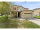 Two-story house with attached garage and landscaping at 10617 Bamboo Rod Cir, Riverview, FL 33569