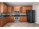 Modern kitchen with stainless steel appliances and wood cabinets at 10617 Bamboo Rod Cir, Riverview, FL 33569
