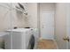 Laundry room with washer, dryer, and shelving at 10617 Bamboo Rod Cir, Riverview, FL 33569