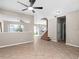 Open living room with tile floors, high ceilings, and staircase at 10617 Bamboo Rod Cir, Riverview, FL 33569