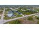 Property view showcasing home, road, and surrounding lots at 10071 Kingsville Dr, Port Charlotte, FL 33981