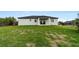 House with grassy backyard at 10071 Kingsville Dr, Port Charlotte, FL 33981