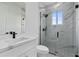 Modern bathroom with marble shower and white vanity at 10071 Kingsville Dr, Port Charlotte, FL 33981