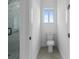Clean bathroom with toilet and window at 10071 Kingsville Dr, Port Charlotte, FL 33981