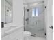 Modern bathroom with marble shower and white vanity at 10071 Kingsville Dr, Port Charlotte, FL 33981