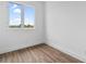 Simple bedroom with wood-look floors and window at 10071 Kingsville Dr, Port Charlotte, FL 33981