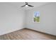 Bright bedroom with wood-look floors and ceiling fan at 10071 Kingsville Dr, Port Charlotte, FL 33981