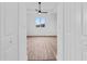 Bright bedroom with wood-look floors and ceiling fan at 10071 Kingsville Dr, Port Charlotte, FL 33981