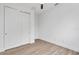 Spacious bedroom with double door closet and wood-look floors at 10071 Kingsville Dr, Port Charlotte, FL 33981