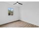 Bright bedroom with wood-look floors and ceiling fan at 10071 Kingsville Dr, Port Charlotte, FL 33981