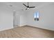 Spacious bedroom with wood-look floors and ceiling fan at 10071 Kingsville Dr, Port Charlotte, FL 33981