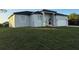 Contemporary single-Gathering home boasts neutral stucco, double-door entry, and an attached two-car garage at 10071 Kingsville Dr, Port Charlotte, FL 33981