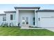 New construction home with gray exterior, white garage door, and landscaped lawn at 10071 Kingsville Dr, Port Charlotte, FL 33981
