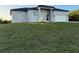 Contemporary single-Gathering home boasts neutral stucco, double-door entry, and an attached two-car garage at 10071 Kingsville Dr, Port Charlotte, FL 33981