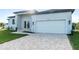 Contemporary home with white garage door and landscaped front yard at 10071 Kingsville Dr, Port Charlotte, FL 33981