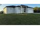 Contemporary single-Gathering home boasts neutral stucco, double-door entry, and an attached two-car garage at 10071 Kingsville Dr, Port Charlotte, FL 33981