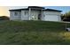Contemporary single-Gathering home boasts neutral stucco, double-door entry, and an attached two-car garage at 10071 Kingsville Dr, Port Charlotte, FL 33981