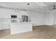 Modern kitchen island with white cabinets and quartz countertops at 10071 Kingsville Dr, Port Charlotte, FL 33981