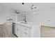 White kitchen island with quartz countertop and sink at 10071 Kingsville Dr, Port Charlotte, FL 33981