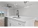 Kitchen island with double sink, quartz countertop, and modern fixtures at 10071 Kingsville Dr, Port Charlotte, FL 33981