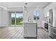 Modern kitchen with island, stainless steel appliances, and sliding glass doors to backyard at 10071 Kingsville Dr, Port Charlotte, FL 33981