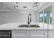 Modern kitchen island with quartz countertop and sink at 10071 Kingsville Dr, Port Charlotte, FL 33981