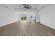 Spacious living room with hardwood floors and ceiling fan at 10071 Kingsville Dr, Port Charlotte, FL 33981