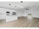 Open living room with hardwood floors and kitchen with island at 10071 Kingsville Dr, Port Charlotte, FL 33981