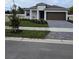 New construction home with two-car garage and landscaped yard at 9613 Vibrant Lane, Venice, FL 34292