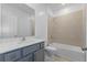 Clean bathroom with bathtub and grey tile at 17351 Peregrine Way, Punta Gorda, FL 33982