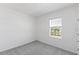 Bright bedroom with grey carpet and large window at 17351 Peregrine Way, Punta Gorda, FL 33982