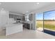 Kitchen with gray cabinets, an island, and sliding glass doors to the patio at 17351 Peregrine Way, Punta Gorda, FL 33982