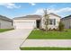 One-story home with a two-car garage and landscaped lawn at 37501 Williamette Way, Zephyrhills, FL 33540